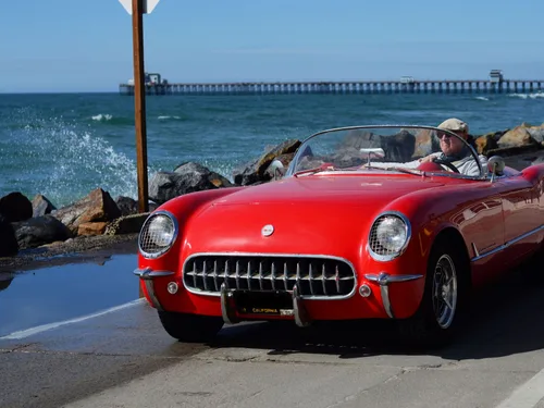 An open-top car on a coastal weekend drive